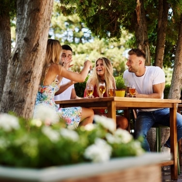 Family sitting around eating outside.